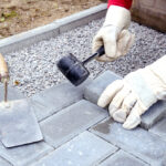 Bricklayer,Places,Concrete,Paving,Stone,Blocks,For,Building,Up,A