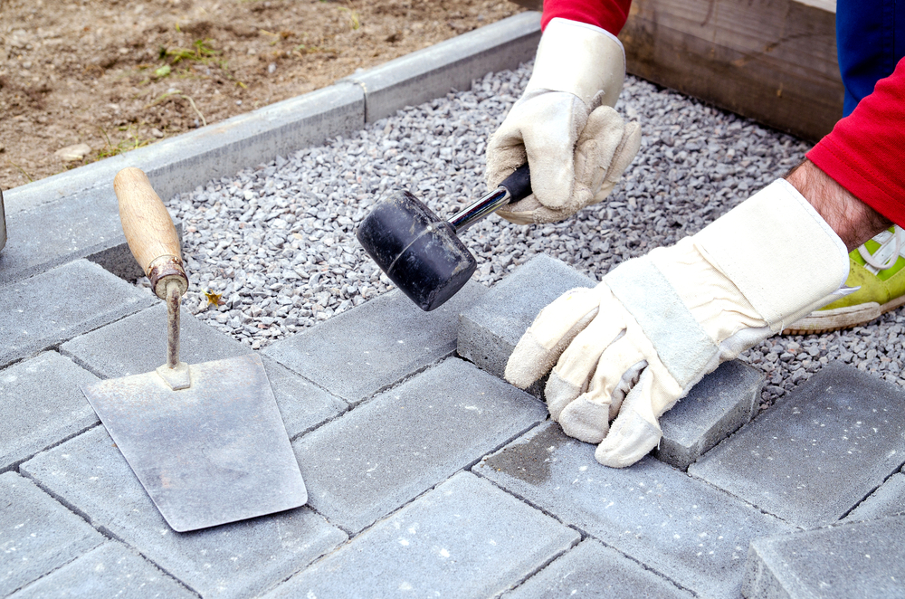Bricklayer,Places,Concrete,Paving,Stone,Blocks,For,Building,Up,A